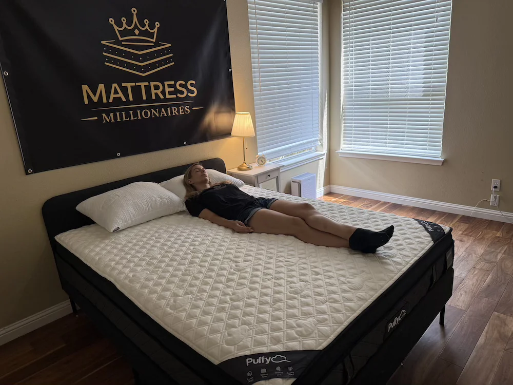 Back sleeping position on Puffy Lux Hybrid mattress showing body alignment