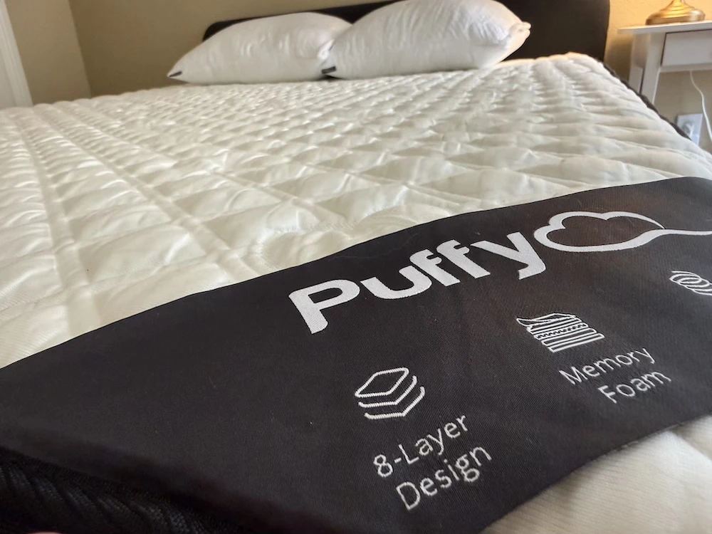 Puffy Lux Hybrid mattress close-up showing quilted cover and branding