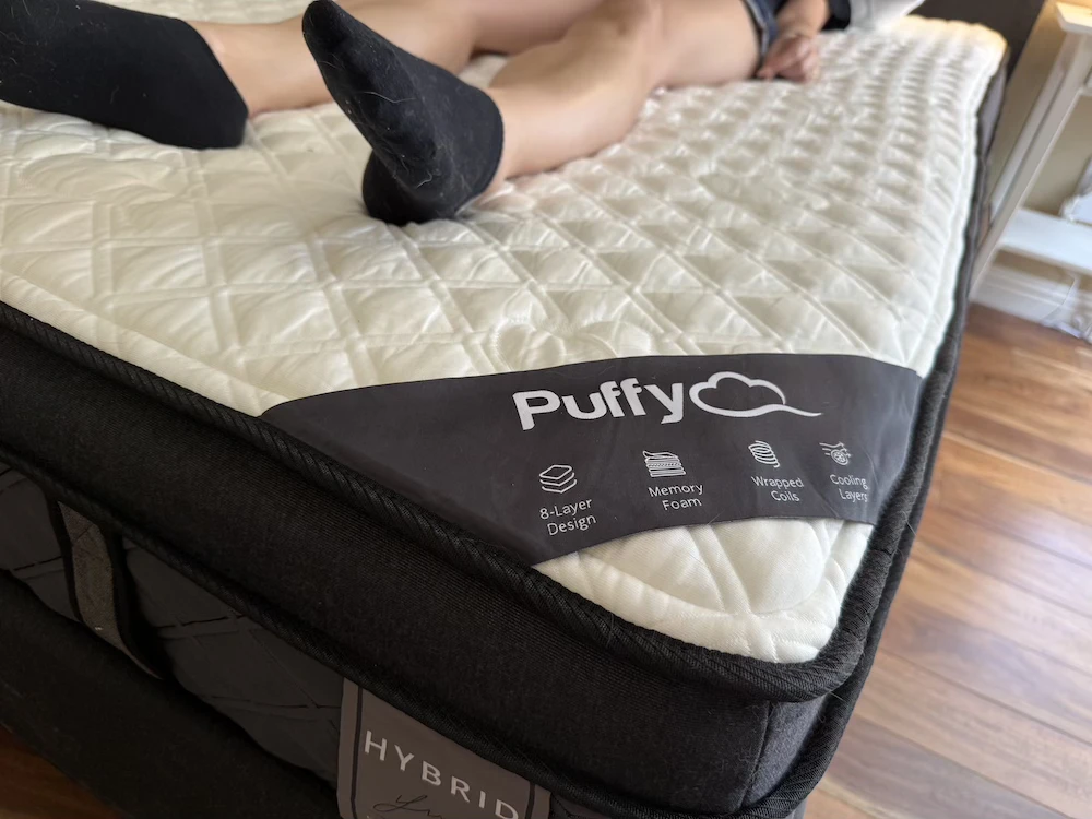 Puffy Lux Hybrid corner view showing 8-layer design and foam construction