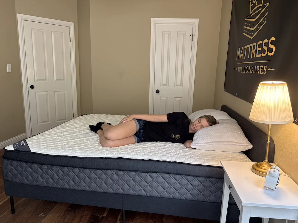 Side sleeper evaluating hip pressure on Puffy Lux Hybrid