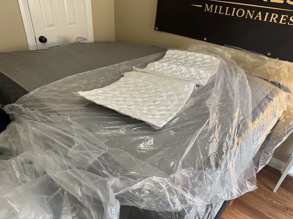 Puffy Lux Hybrid mattress expanding with included pillows