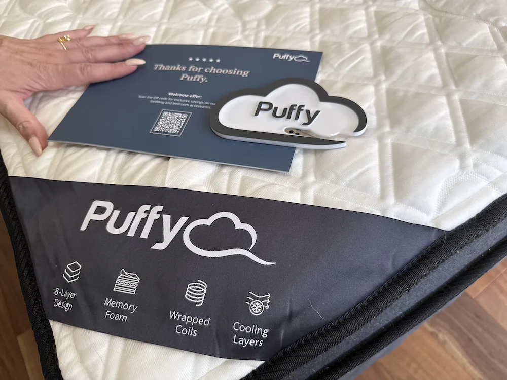 Puffy Lux Hybrid mattress close-up showing quilted cover and branding