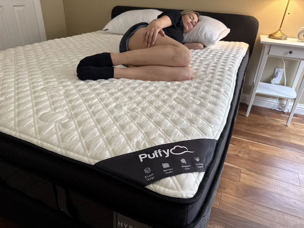Side sleeper on Puffy Lux Hybrid showing hip and shoulder pressure relief