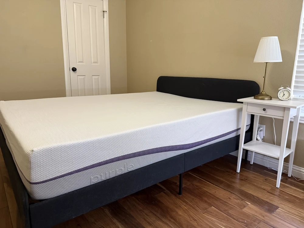 Fully set up Purple Plus mattress on bed frame