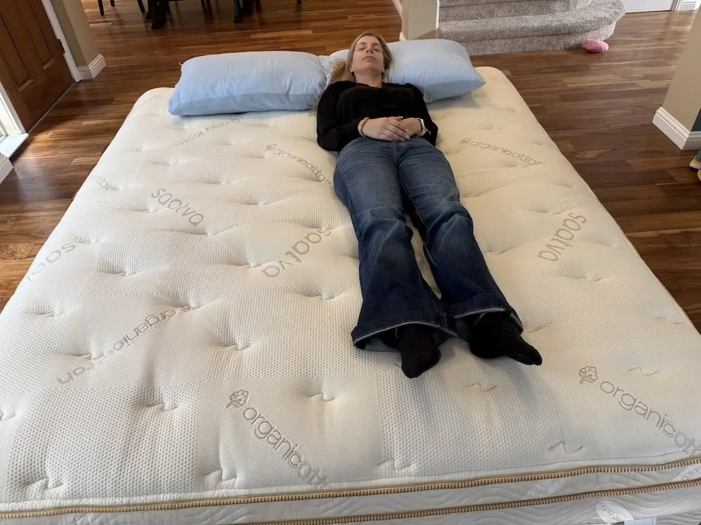 Back sleeper lying on the Saatva Classic Luxury Firm mattress during hands-on testing