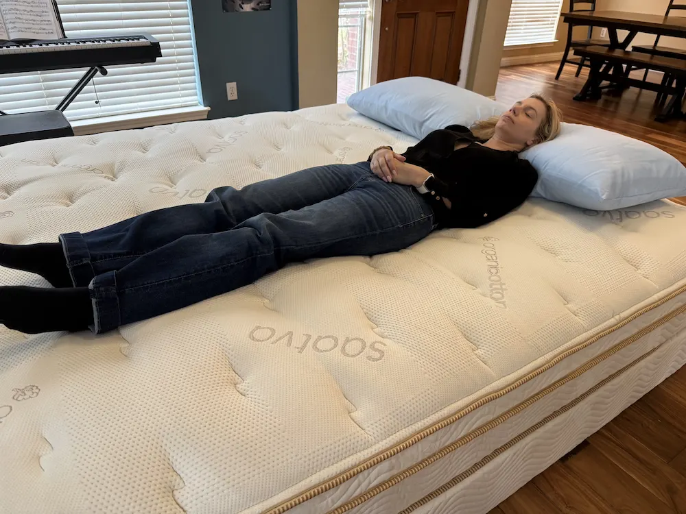 Back sleeping test on Saatva Classic mattress showing spinal alignment