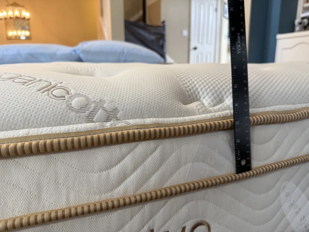 Measuring Saatva Classic mattress height with ruler showing profile thickness
