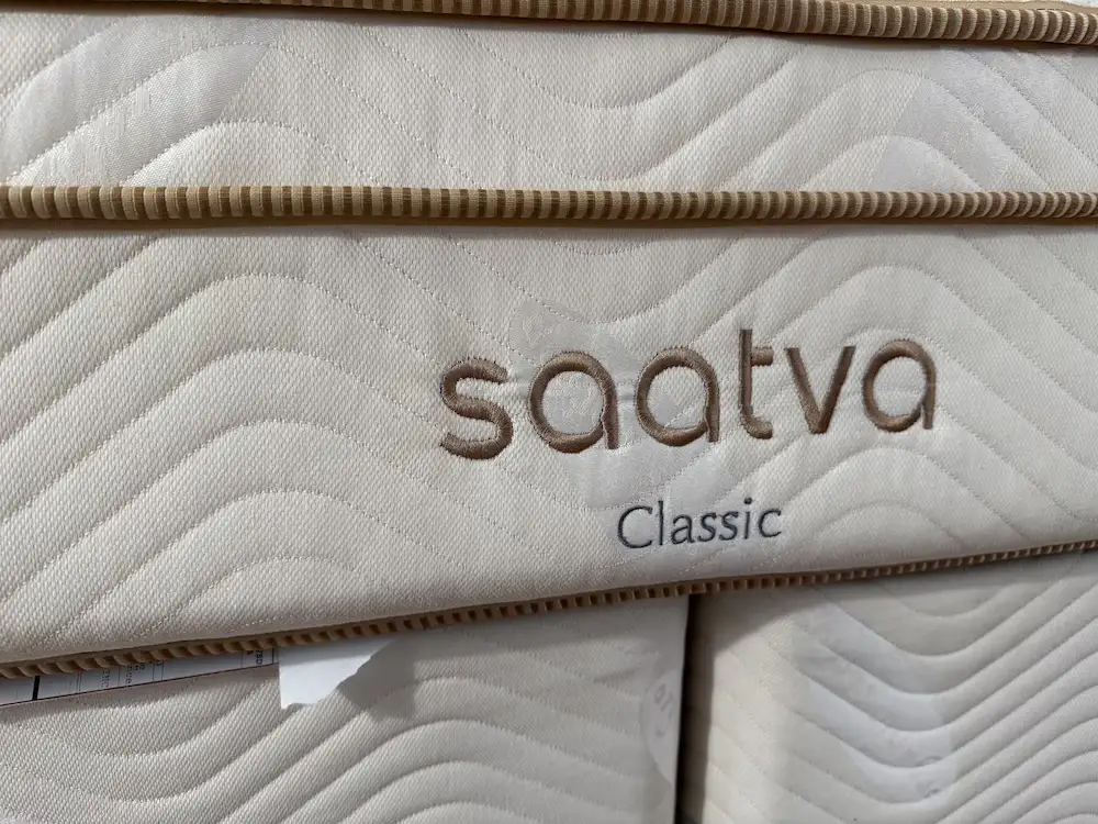 Close-up of Saatva Classic mattress label and quilted side panel