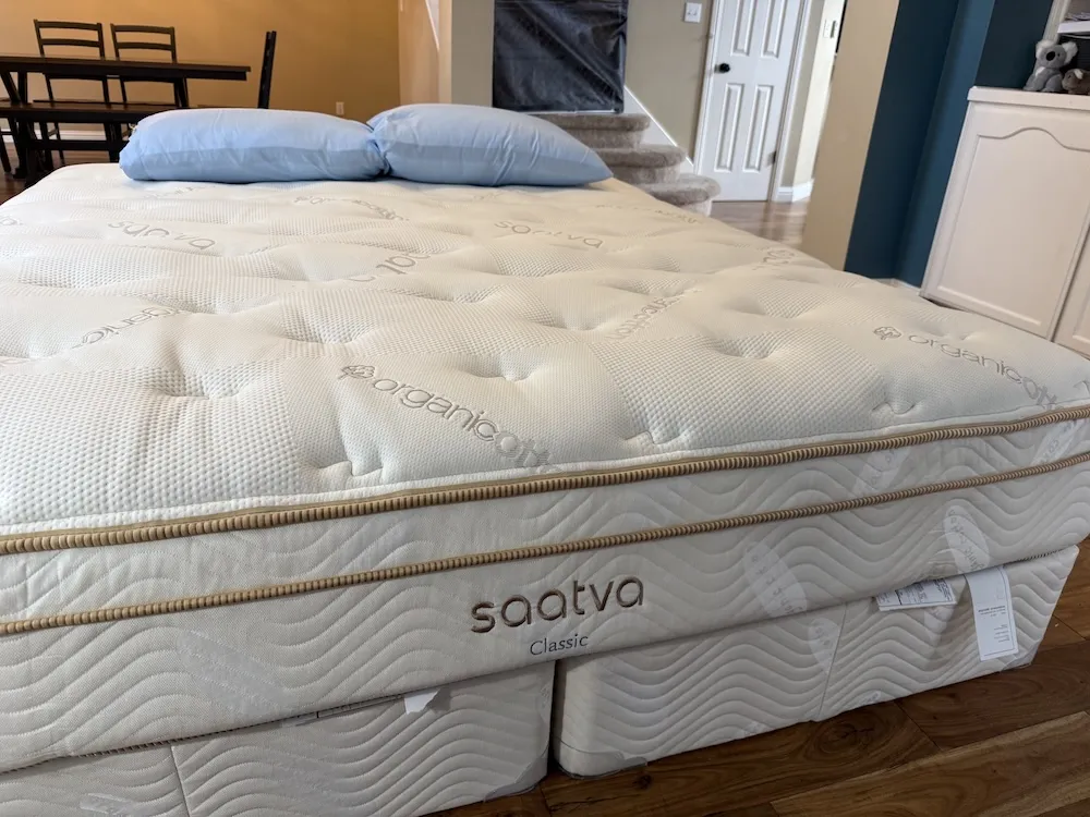 Saatva Classic Luxury Firm mattress shown in bedroom with quilted Euro pillow top and organic cotton cover
