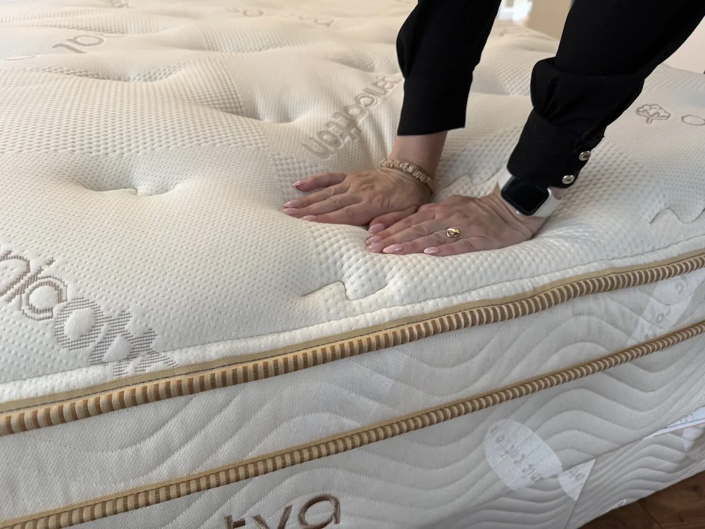 Hand pressure test on Saatva Classic Euro top showing plush cushioning