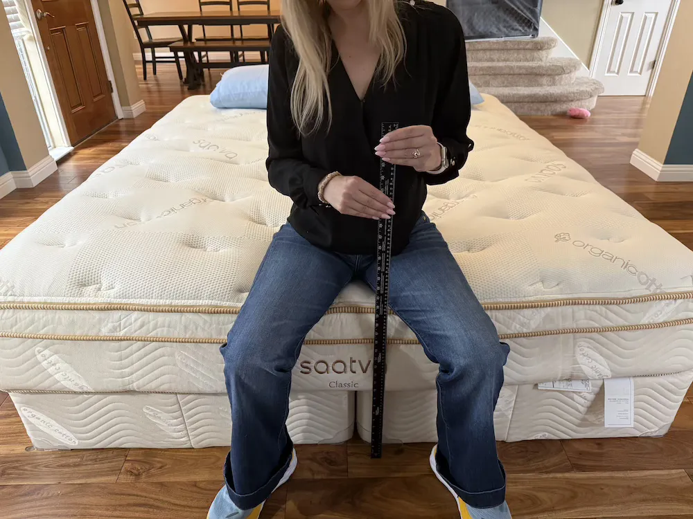Measuring seated edge compression on the Saatva Classic mattress