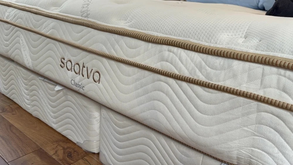 Side view of the Saatva Classic mattress showing its quilted cover and hybrid profile