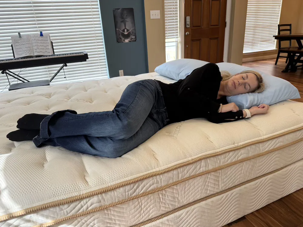 Side sleeper testing pressure relief on the Saatva Classic Luxury Firm mattress