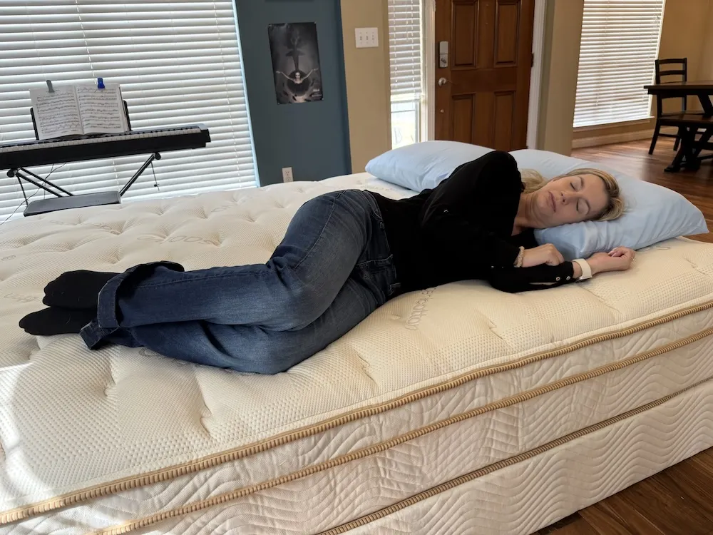 Side sleeping on the Saatva Classic Luxury Firm mattress showing cushioned lift and alignment