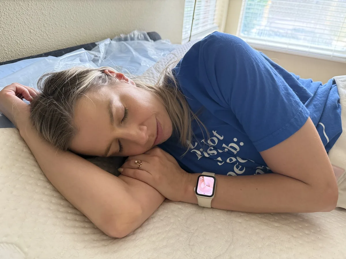 Person resting on a mattress in a cool bedroom environment