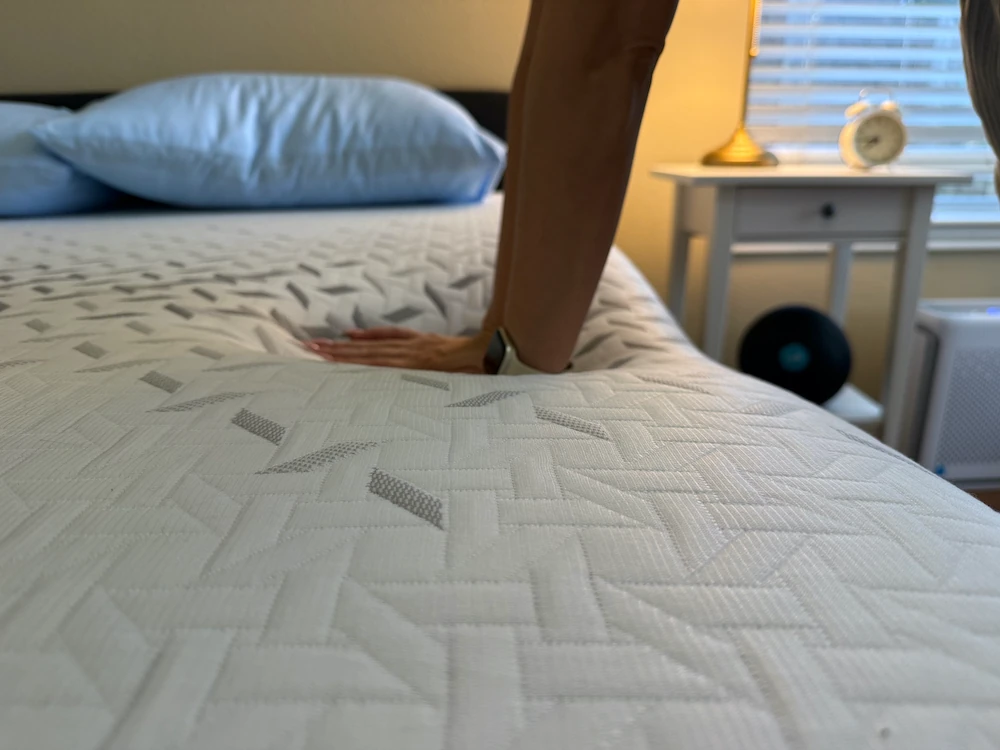 An image of a woman edge testing a Nectar Premier mattress