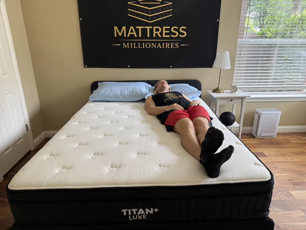 Tester lying on their back on the Titan Plus Luxe mattress