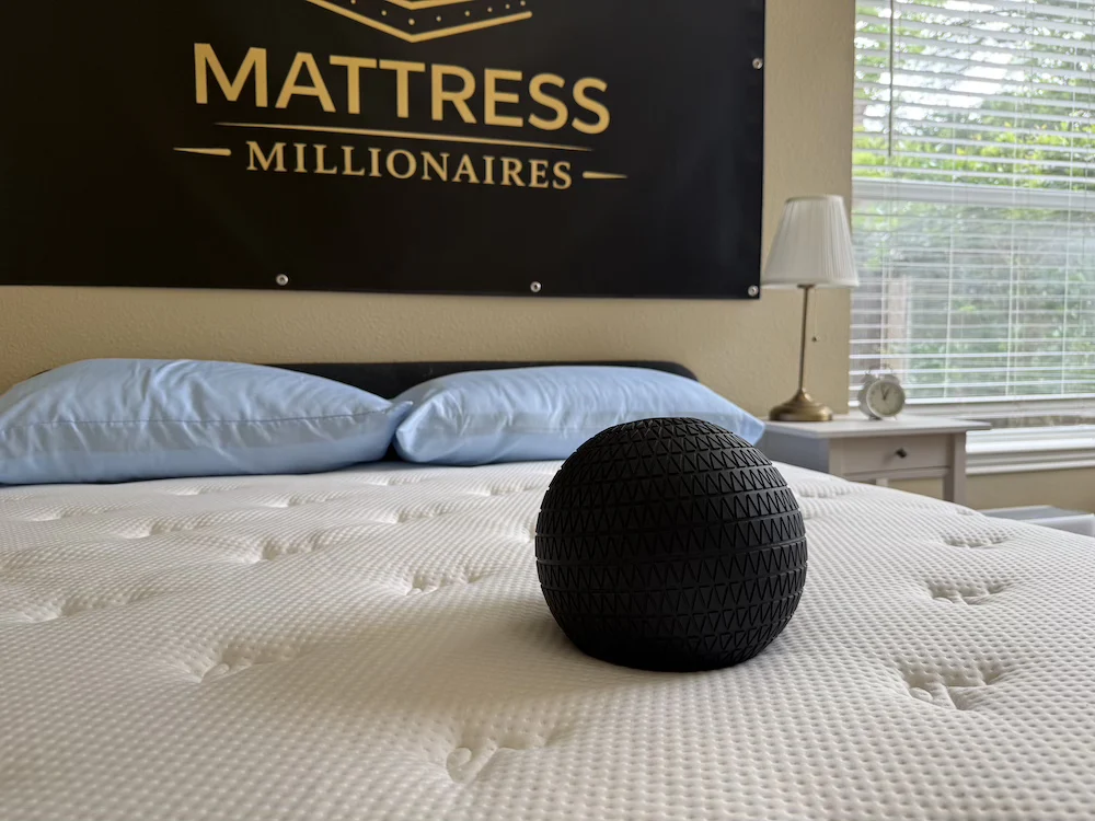 Weighted ball resting on the Titan Plus Luxe mattress during sinkage testing