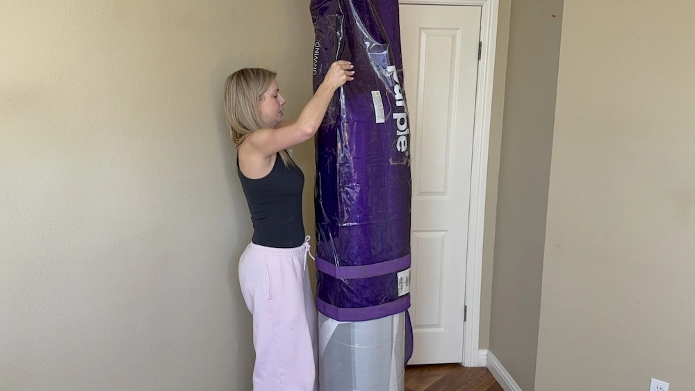 Unrolling Purple Plus mattress as it expands