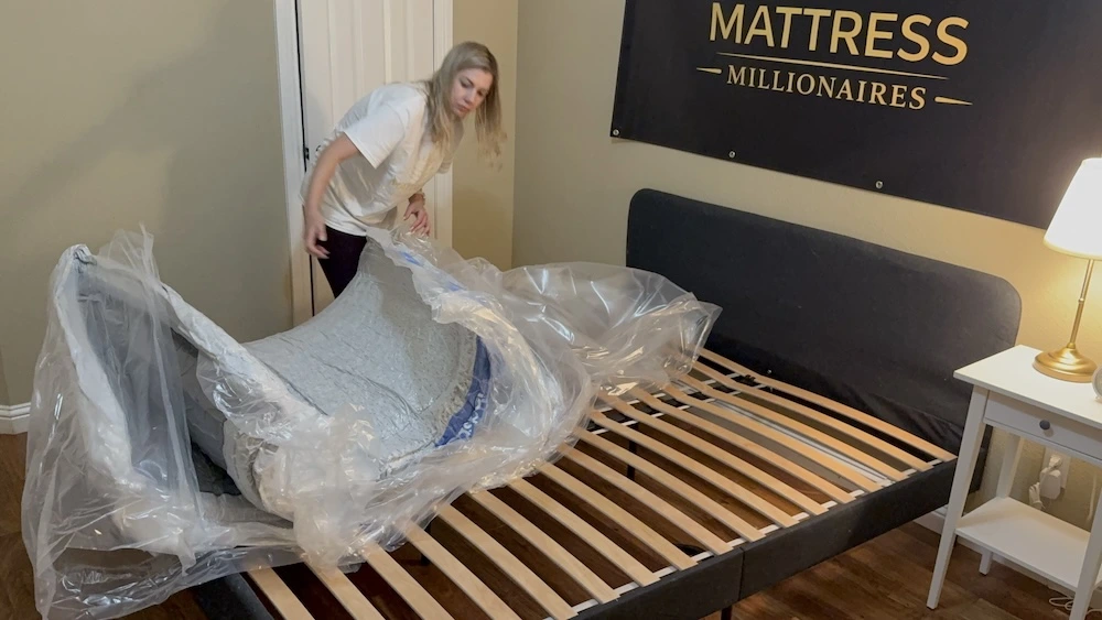 Removing the plastic packaging from the Casper Dream mattress during unboxing