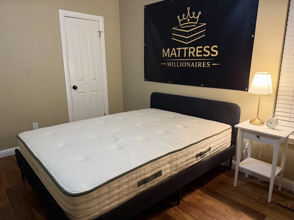 Used mattress on a bed in the Mattress Millionaires testing room before removal or donation