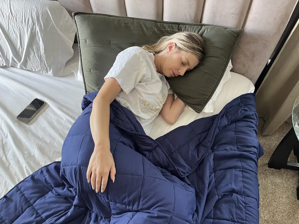 Overhead view of a person sleeping under a weighted blanket