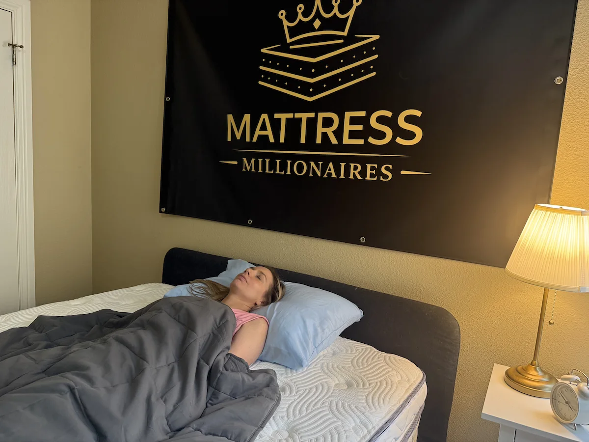 Woman resting comfortably under a weighted blanket while preparing for sleep