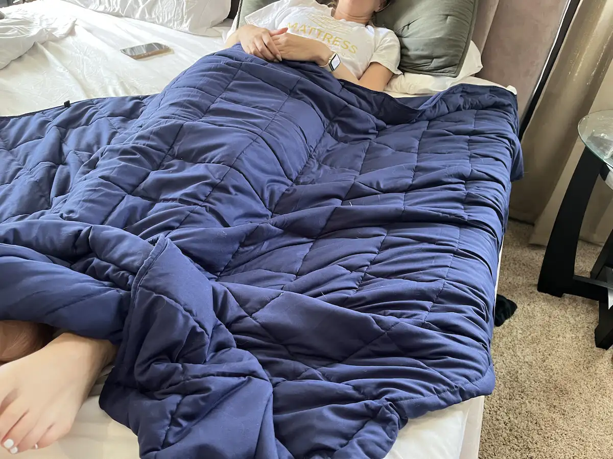 Wide view of a weighted blanket covering the body during sleep