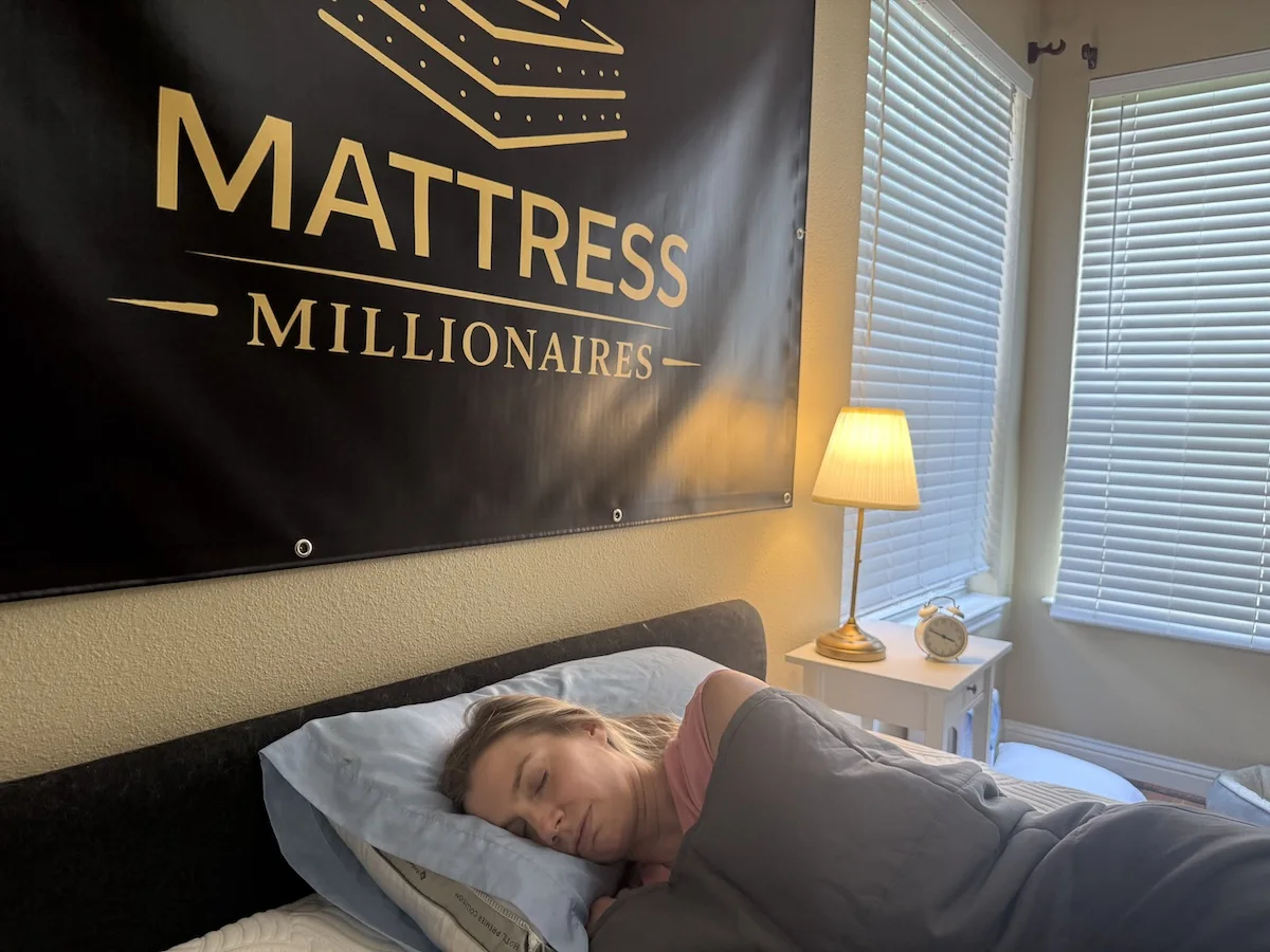 Side sleeper relaxing beneath a weighted blanket in a quiet bedroom