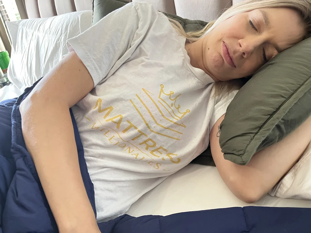 Side sleeper resting comfortably beneath a weighted blanket