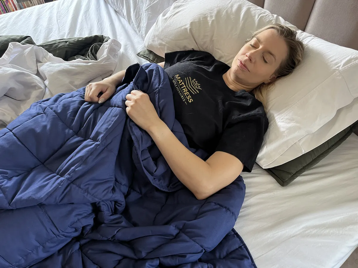 Sleeper resting beneath a weighted blanket in a breathable sleep setup