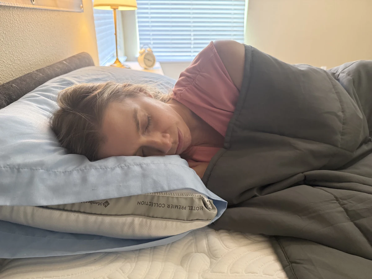 Close-up of a sleeper using a weighted blanket for gentle pressure and comfort