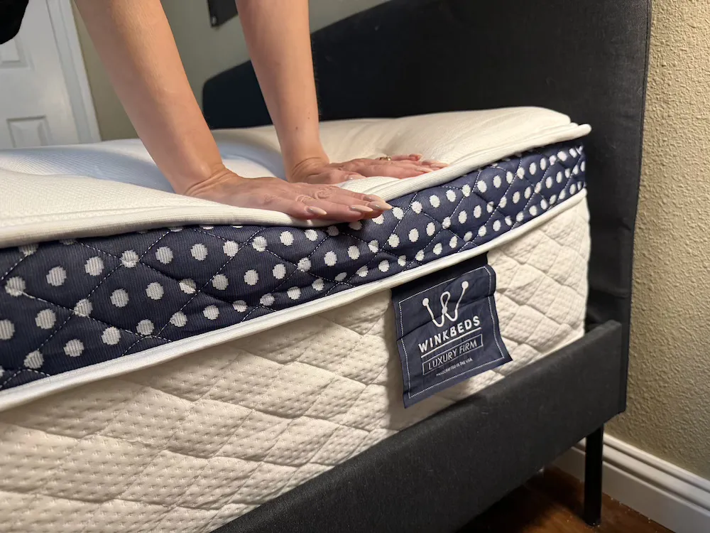 Hands testing WinkBed Luxury Firm edge support