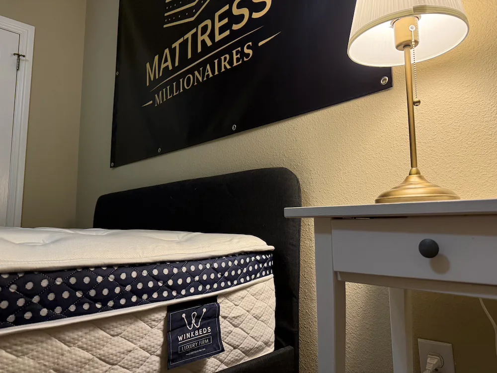 WinkBed Luxury Firm mattress shown on bed frame in Mattress Millionaires testing room
